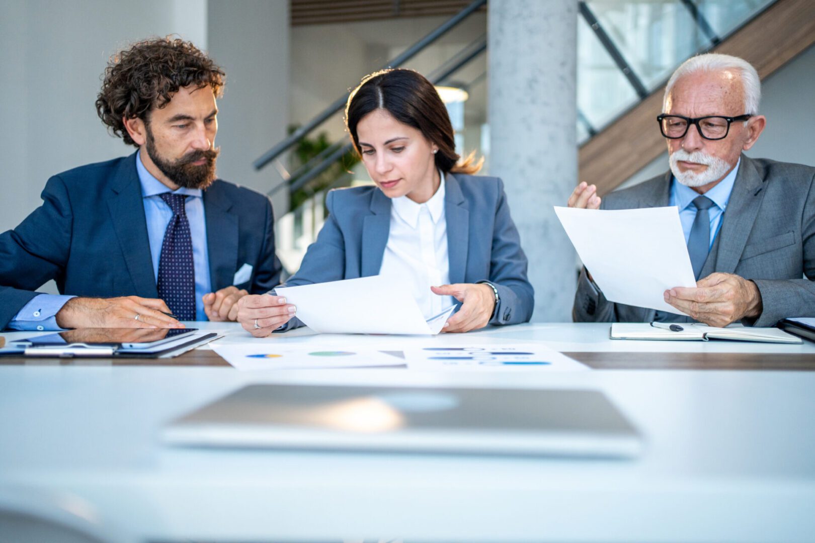 Professionals discussing paperwork in office